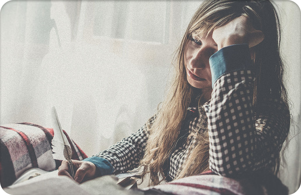 sad looking woman writing