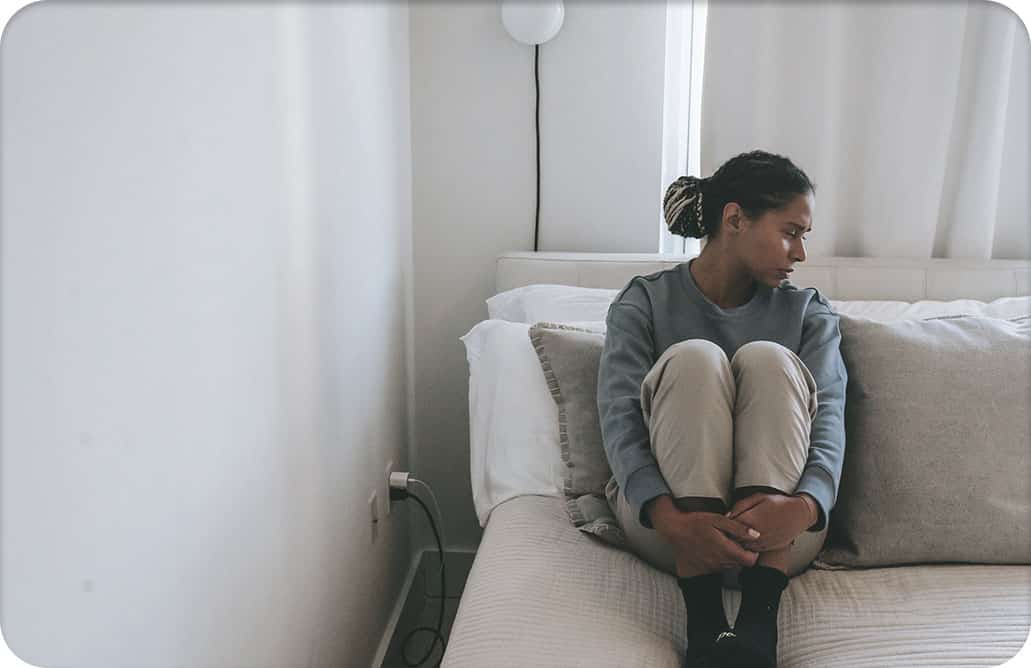 Woman sitting on couch, looking to the side