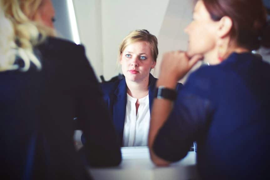 What is high functioning anxiety hosted by Wellin5 online counselling platform. Image is of a woman looking stressed and anxious in a work setting.